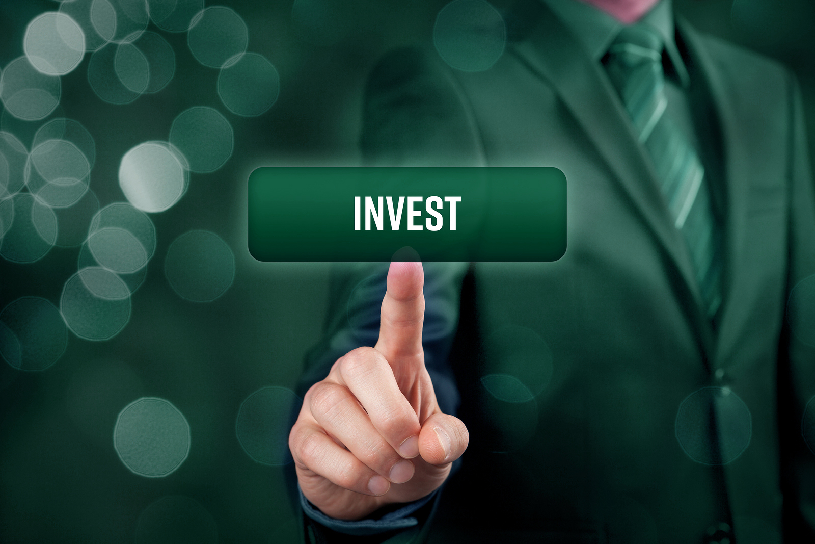 Invest concept. Investor (trader) click on button with text invest.